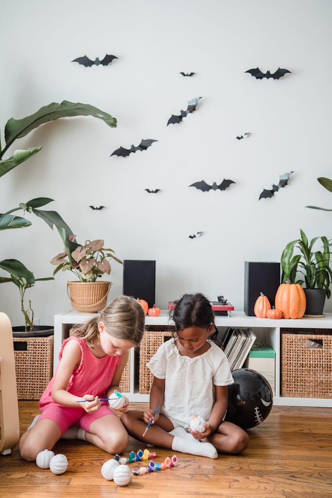Little girls making halloween decorations