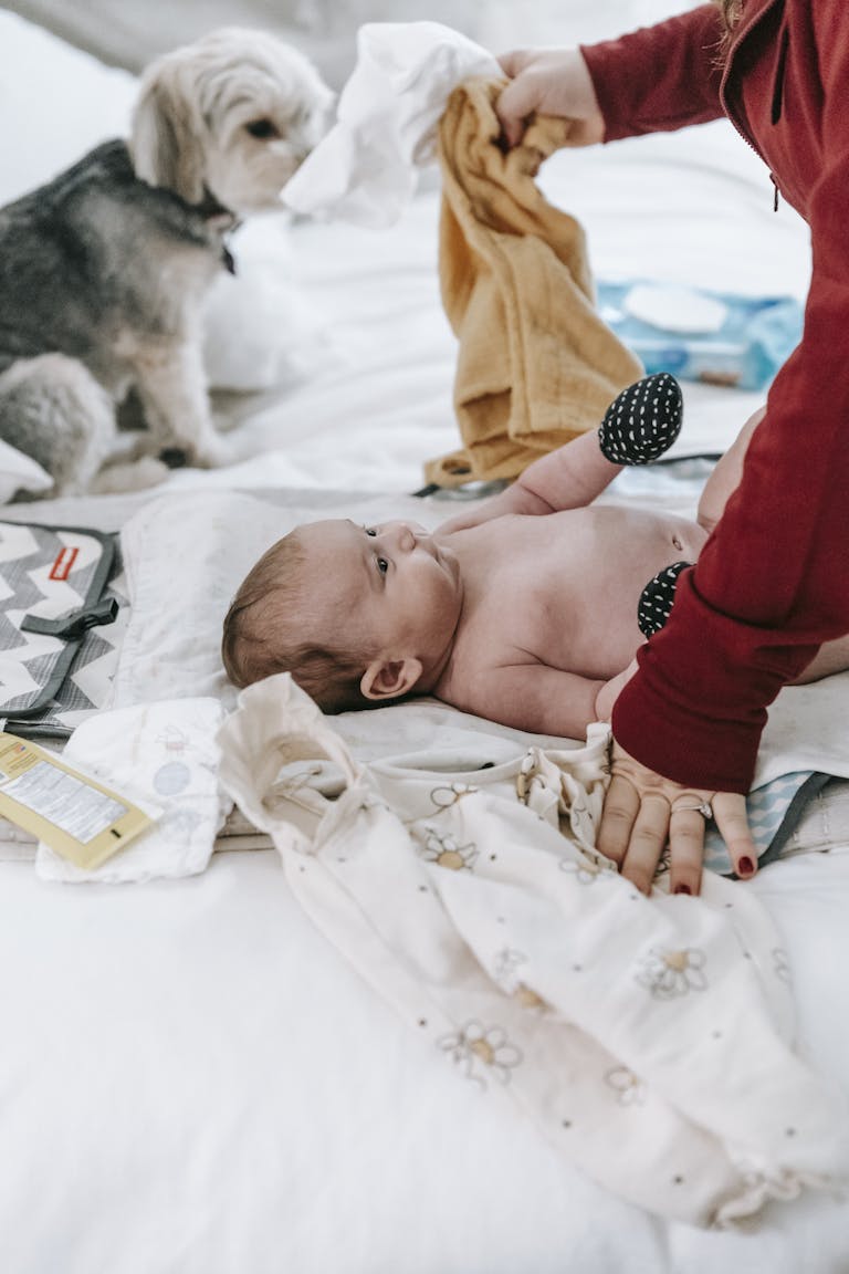 A mother changes her baby's diaper. Cloth diapers